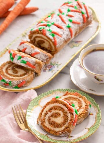 A close up of slices of a carrot cake roll on a plate