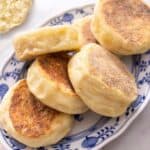 A close up of English Muffins on a serving plate.