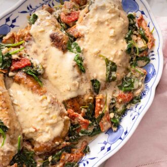 Pinterest graphic of a close up of a plate of Tuscan chicken by a pink linen.