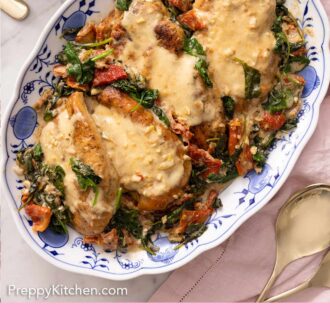 Pinterest graphic of a plate of four servings of Tuscan chicken with spinach, sun-dried tomatoes, and a creamy sauce.