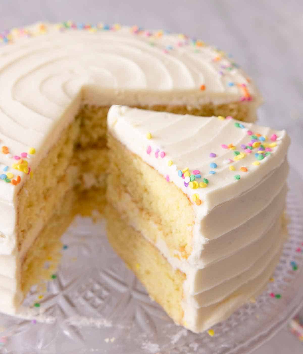 A slice of vanilla cake cut and separated from the cake.