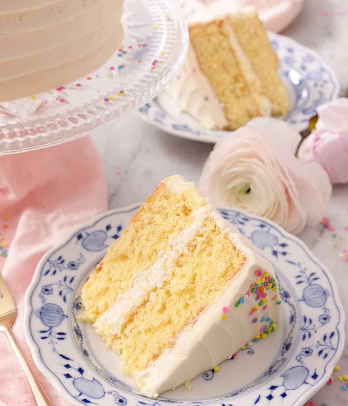 A blue plate with a slice of layered vanilla cake.