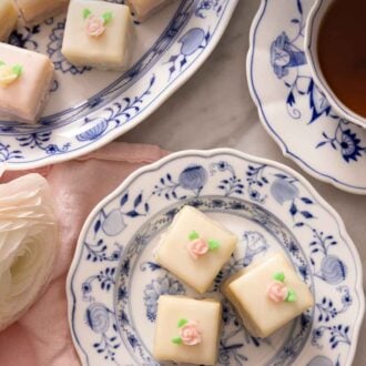 Pinterest graphic of petit fours in two plates, beside a cup of tea.