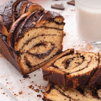 Pinterest graphic of a cut loaf of babka, with two slices in front of it, stacked on top of each other.