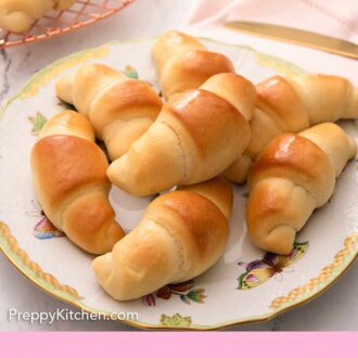 Pinterest graphic of crescent rolls on a plate on top of a pink linen napkin.