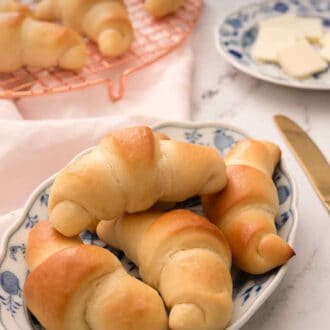 Pinterest graphic of four rolls on a white and blue plate with more behind it.