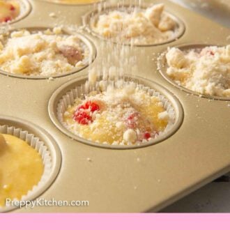 Pinterest image of streusel being added to muffins before baking.