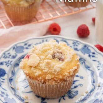 Pinterest image of a raspberry muffin with streusel on top. A cooling rack with more muffins are in the background.