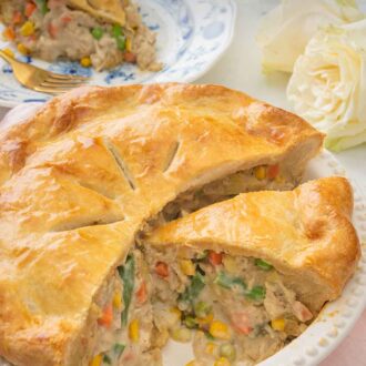 Pinterest graphic of a cut open turkey pot pie with a slice on a plate in the background.