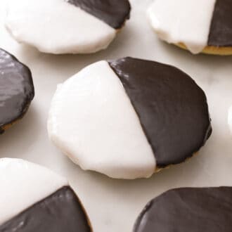Black and white cookies on a marble surface.