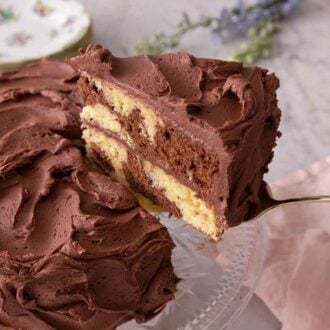 Pinterest graphic of a slice of marble cake being lifted up, after its been cut.