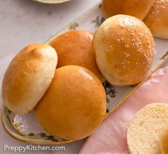 Pinterest graphic of a platter of brioche buns with a couple that are cut around it.