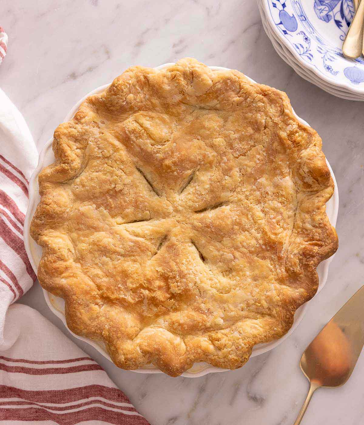 Overhead view of a chicken pot pie, uncut, in its baking dish.