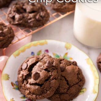 Pinterest graphic a plate of two double chocolate chip cookies with a cooling rack in the background with more cookies.