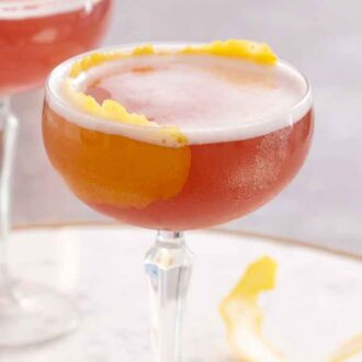 Two glasses of French martini with one in front of the other, in focus.