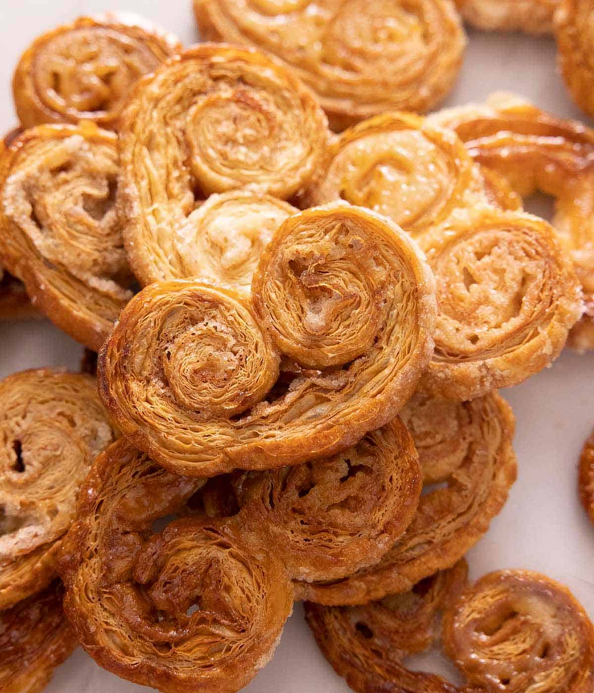 A pile of palmiers, stacked on top of each other with one pamier at the top.