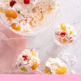 Pinterest graphic of the overhead view of a serving bowl of ambrosia salad with three servings scooped out into individual cups.