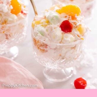 Pinterest graphic of three servings of ambrosia salads in glass cups, with one in focus in front.