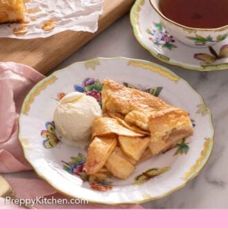 Pinterest graphic of a plate with a slice of apple galette with a scoop of ice cream in front of a cup of tea.