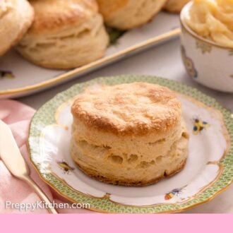 Pinterest graphic of a biscuit on a plate with more biscuits in the background on a platter.