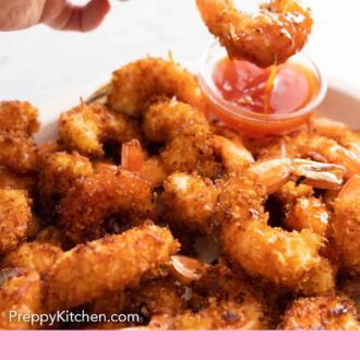 Pinterest graphic of a plate of coconut shrimp with one being dipped into sauce.