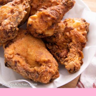 Pinterest graphic of a plate lined with a paper towel containing fried chicken.