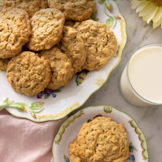 Pinterest graphic of a plate with two peanut butter oatmeal cookies beside a platter of more cookies.