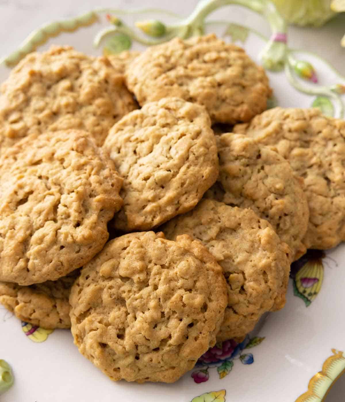 A plate with a bunch of peanut butter oatmeal cookies.