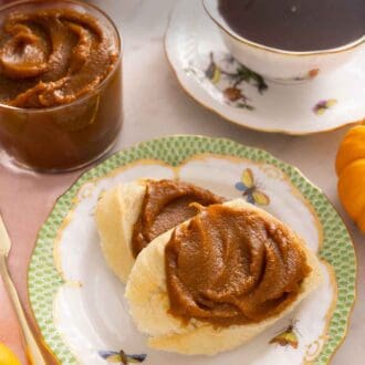 Pinterest graphic of two pieces of bread on a plate with pumpkin butter spread overtop.