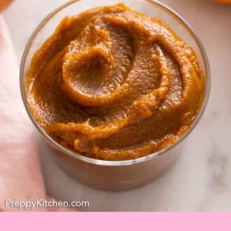 Pinterest graphic of a glass jar of pumpkin butter.