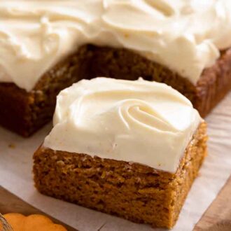A pumpkin cake with one square cut out and pulled forward.