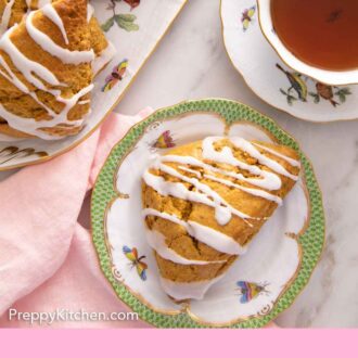 Pinterest graphic of the overhead view of a plate with a pumpkin scones beside a cup of tea by a platter of more scones.