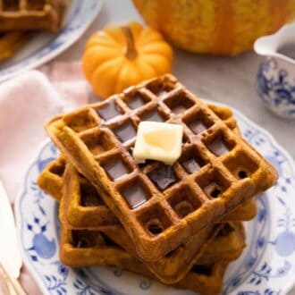 Pinterest graphic of a stack of pumpkin waffles with butter and syrup on top.