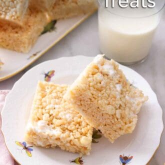 Pinterest graphic of a plate of two rice krispie treats with one propped on the other in front of a glass of milk.