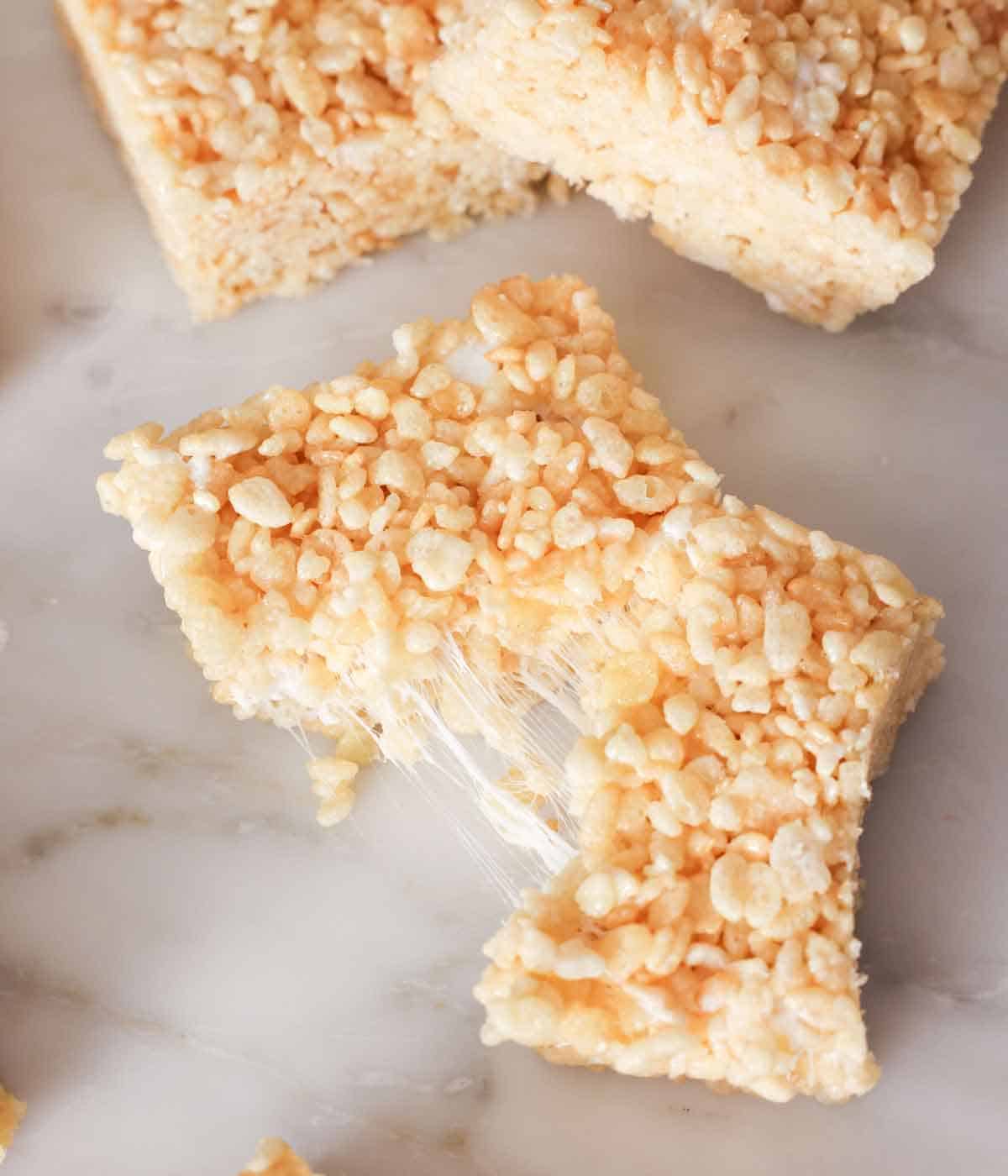 A rice crispy square, torn in half.