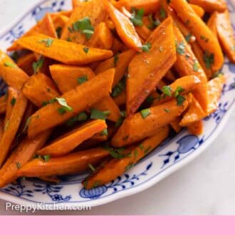 Pinterest graphic of an oval platter of roasted carrots with parsley.