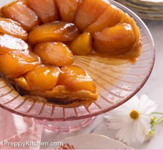 Pinterest graphic of a tarte Tatin with a slice cut out on a pink serving dish.