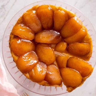 Overhead view of a tarte Tatin with a slice cut and pulled slightly away.
