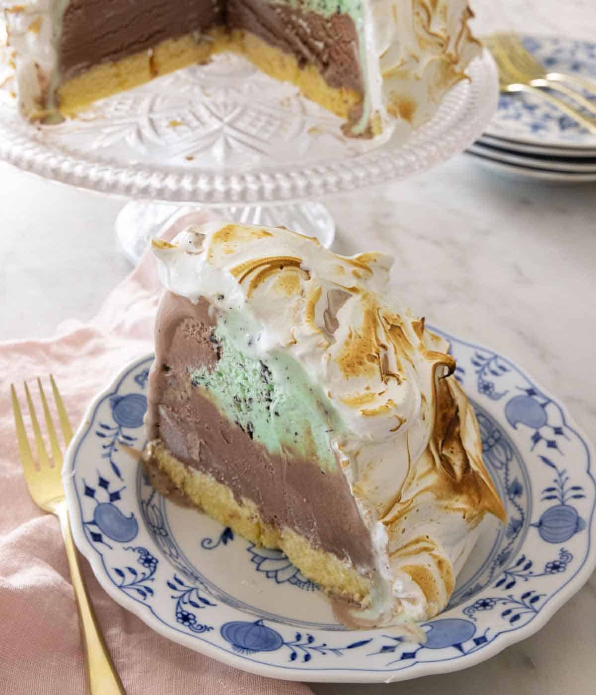 A slice of baked Alaska on a plate with a fork beside it.