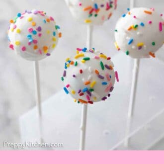 Pinterest graphic of cake pops on a cake stand, holding them upright.