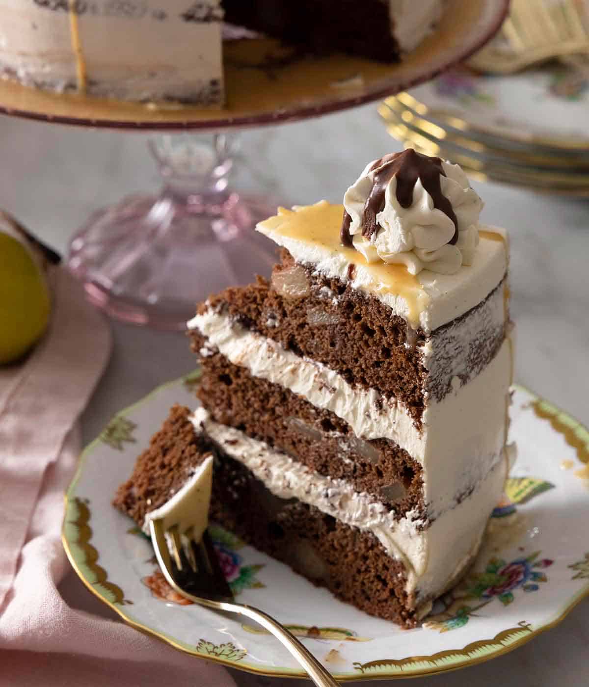A slice of chocolate pear cake with a piece on a fork.