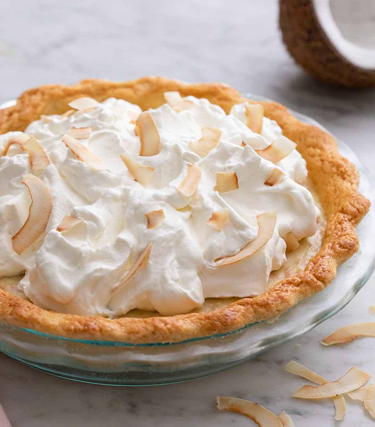A coconut cream pie in a pie dish.