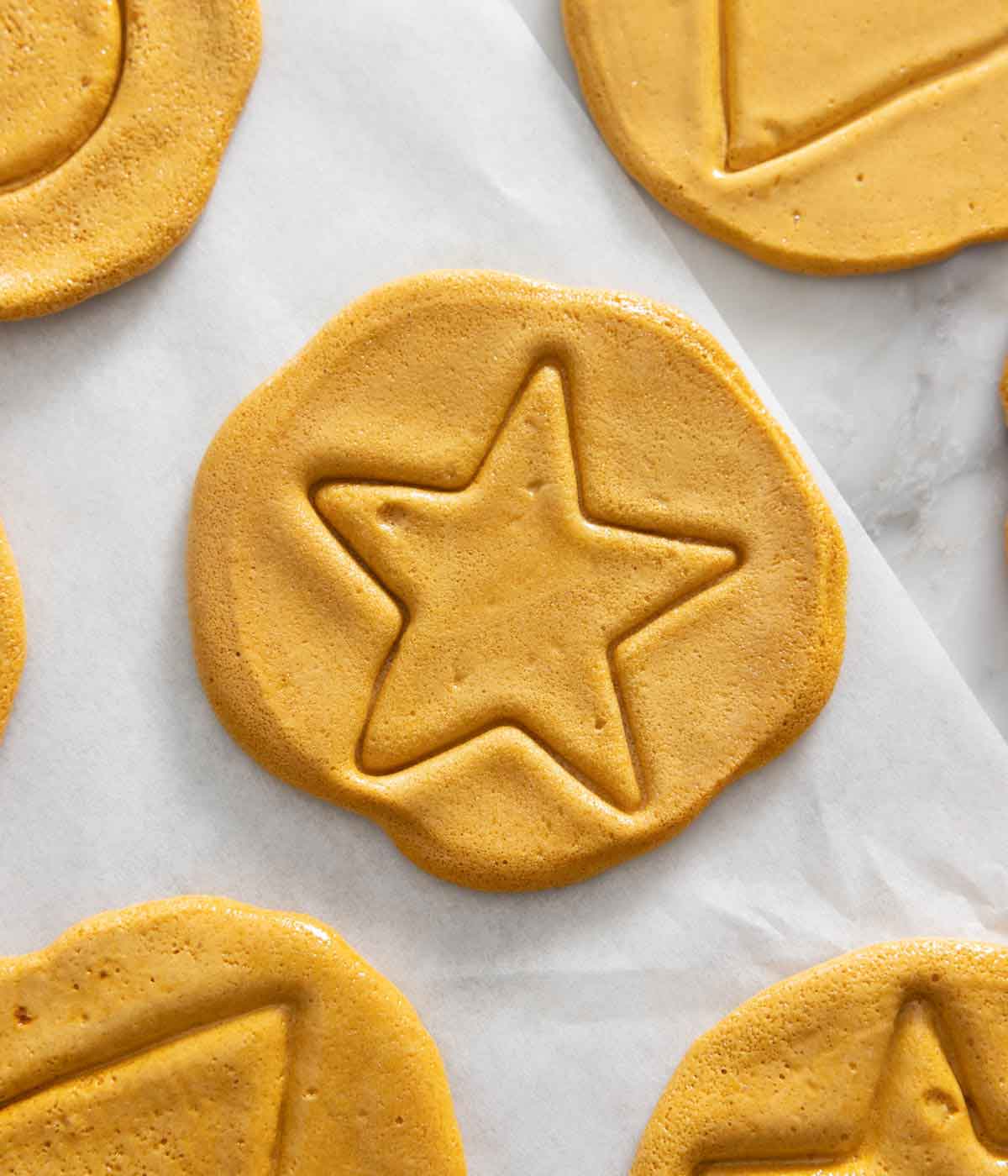 Overhead view of dalgona candy with a star in the middle.