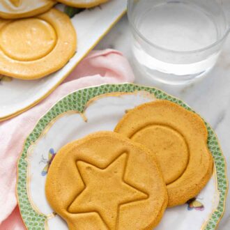 Pinterest graphic of two dalgona candies on a plate.