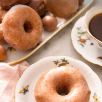 Pinterest graphic of a platter of glazed donuts with a plate in front with one donut.