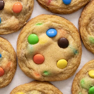 Colorful M&M Cookies on a white counter.