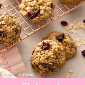 Pinterest graphic of oatmeal cranberry cookies on a cooling rack with two in front.