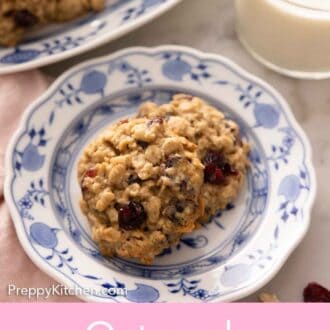 Pinterest graphic of a plate with two oatmeal cranberry cookies.