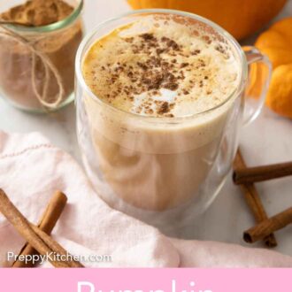 Pinterest graphic of a latte with pumpkin pie spice sprinkled over top with a jar of it in the background.