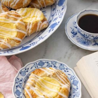 Pinterest graphic of a plate with a cheese danish in front of a platter.